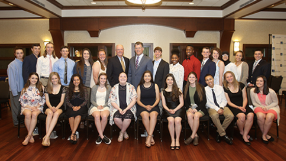 A group of scholarship recipients and AVB employees posing for the camera at an event